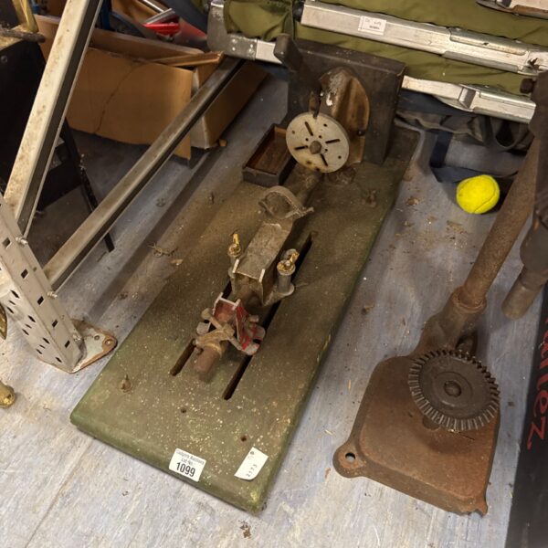 Vintage lathe bench with metal construction and adjustable components.