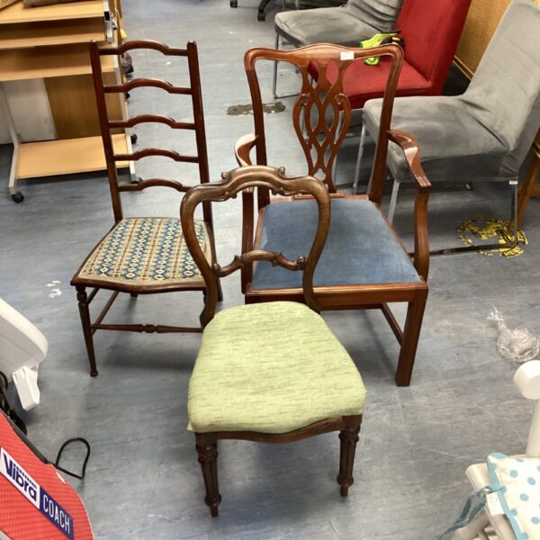 Lot of three vintage mahogany chairs with varying back styles.
