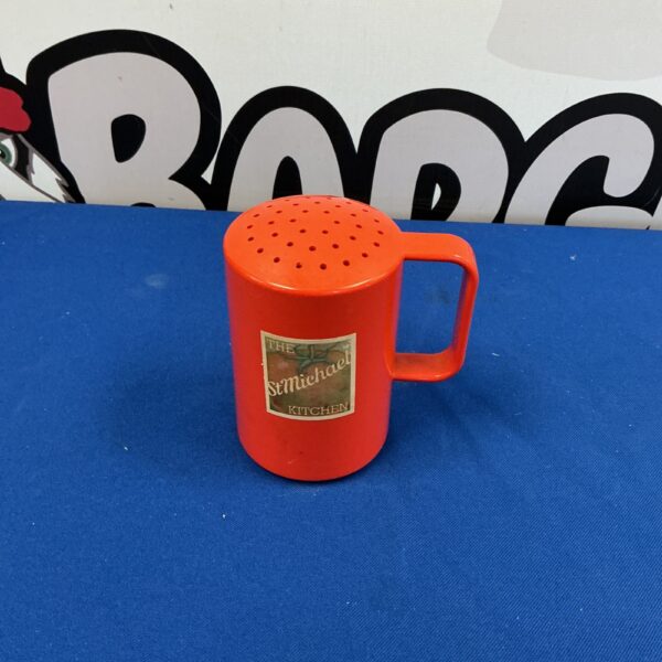 Vintage orange Marks & Spencer sugar shaker for kitchen use.