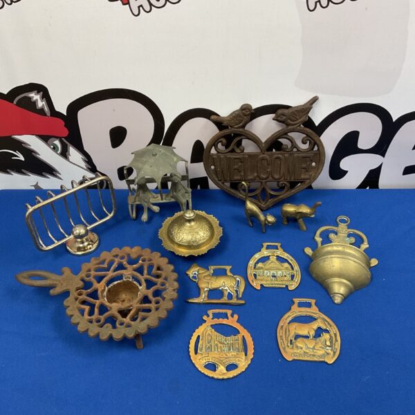 Vintage metalware collection featuring cast iron and brass items.