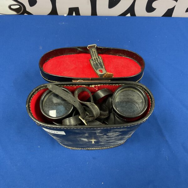Vintage military binoculars in a worn leather case.