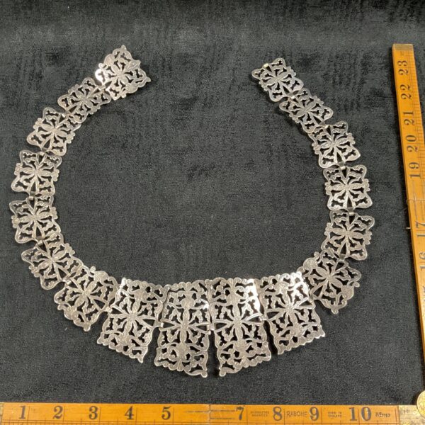 Intricate silver plate vintage nurse belt with floral designs.