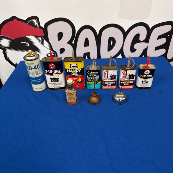 Selection of vintage oil cans, including Handy Oil and Rocket Oil.