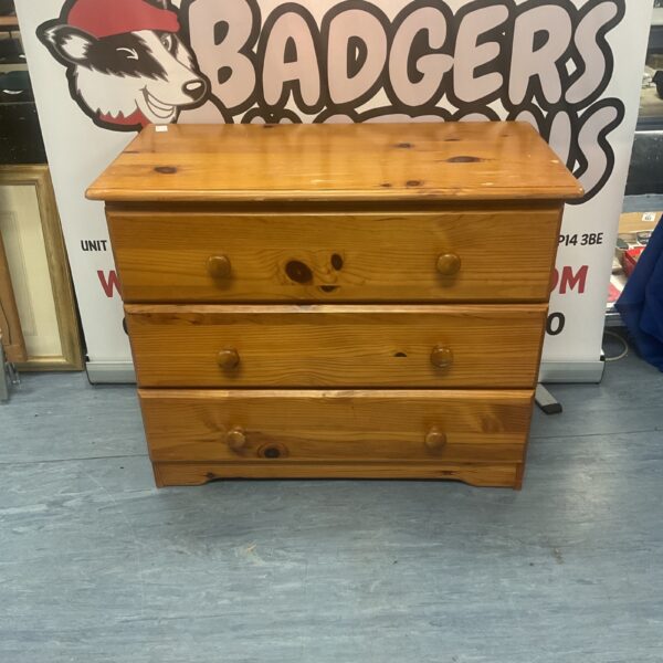 Vintage pine chest of drawers with wooden construction.