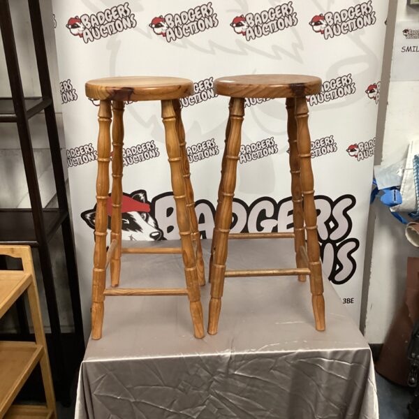 Two vintage pine kitchen stools with rustic charm.