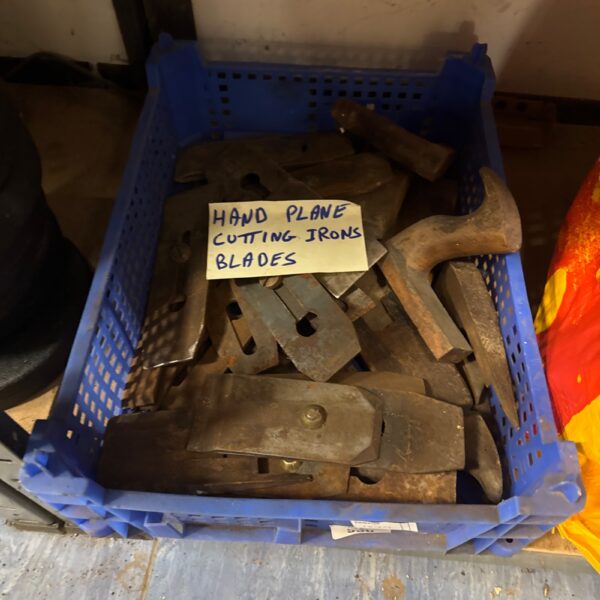 Vintage plane irons and blades in a lot for woodworking.