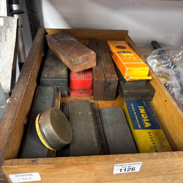 Vintage polishing stones in a tray, antique lapidary tools.