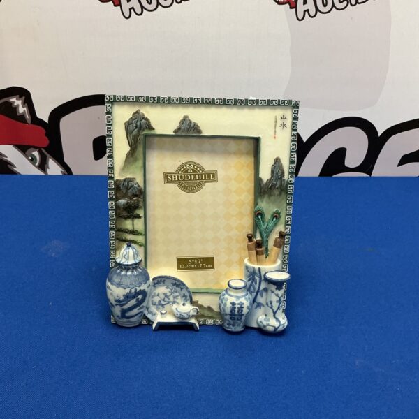 Vintage porcelain photo frame with colourful floral design.