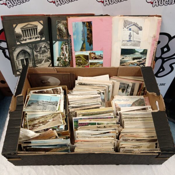 Large collection of vintage postcards in a cardboard box.