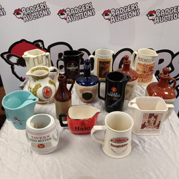 Vintage collection of pub jugs and flagons from various brands.