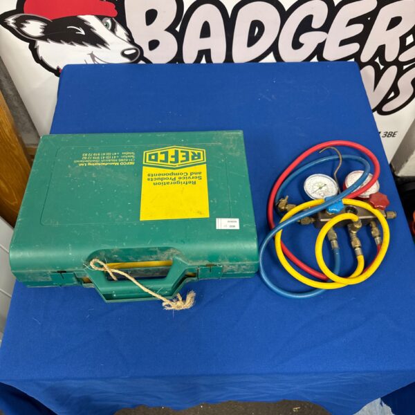 Vintage refrigeration gauge set in green case with hoses.