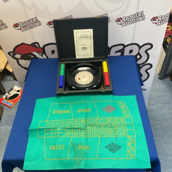 Vintage roulette wheel and mat set for casino games and collectables.