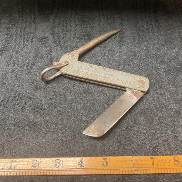 Vintage sailor's jack knife with a folding blade, maritime collectible.
