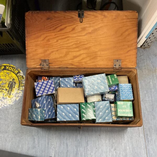 Vintage screw collection in a wooden box, antique fasteners.