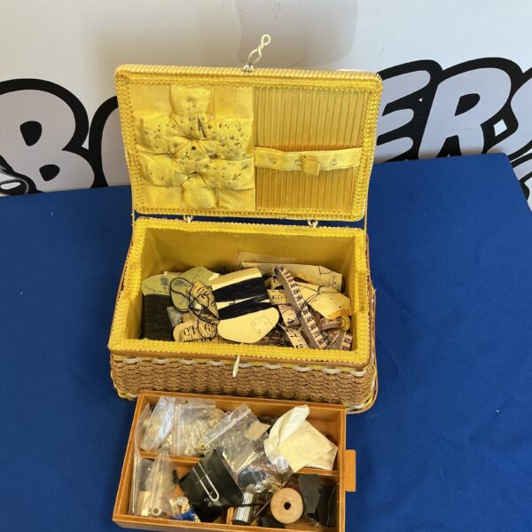 Vintage sewing box filled with antique sewing notions and thread.