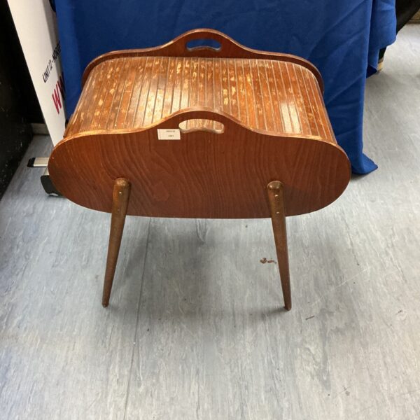 Vintage sewing box with kidney shape and tapered legs.