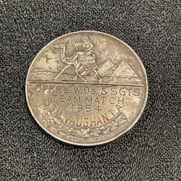 Vintage 1954 shooting medal with Egyptian design and inscription.