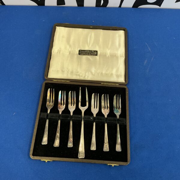 Vintage silverplate cake forks in a presentation case.