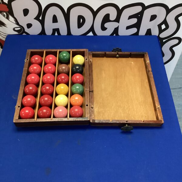 Vintage snooker ball set in wooden case, collectible billiards.