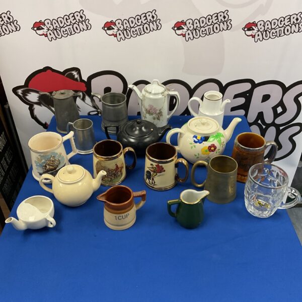 Vintage collection of teapots, tankards and jugs in pewter and brass.