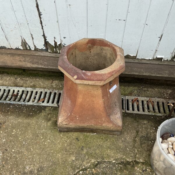 Weathered terracotta chimney pot, vintage garden ornament.