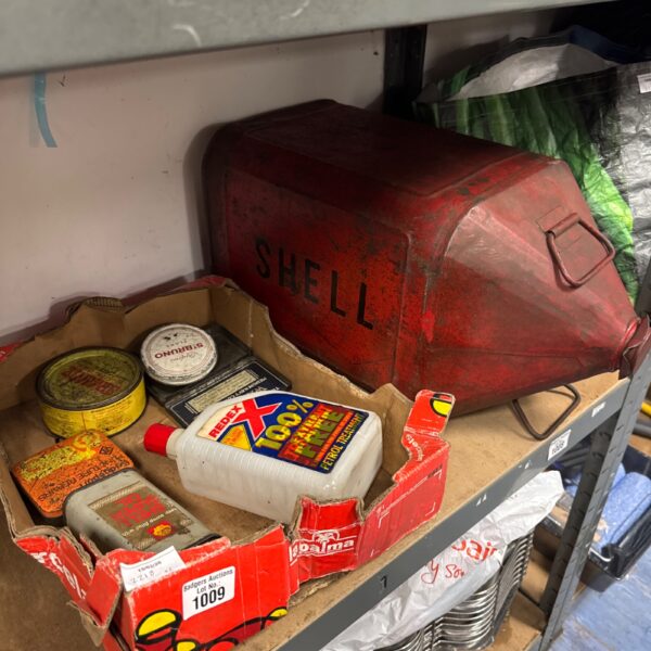 Vintage tins and a Shell fuel can in a lot.