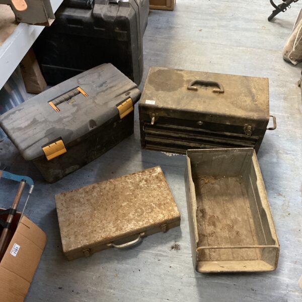 Vintage metal toolboxes and a galvanised tray for workshop storage.
