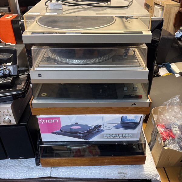 Stack of vintage turntables including Pioneer and Ion record players.