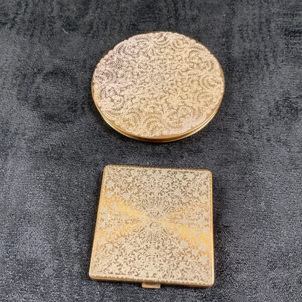 Intricate vintage Vogue compact mirror with detailed decoration.