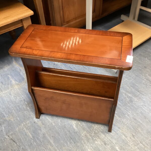 Vintage walnut magazine table with slatted rack for storage.