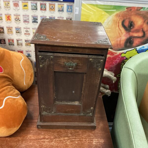 Side view of a vintage wooden coal box with a hinged lid.