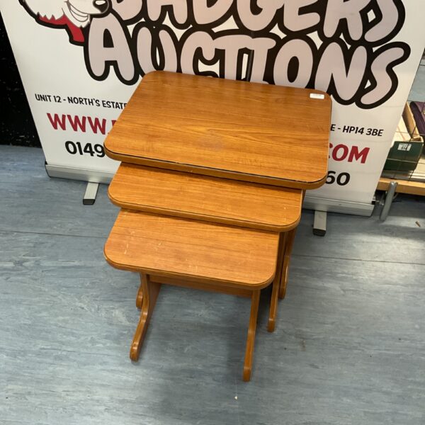 Vintage wooden nest of tables in a warm tone.