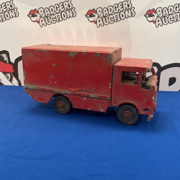 Vintage wooden toy truck with chipped paint.