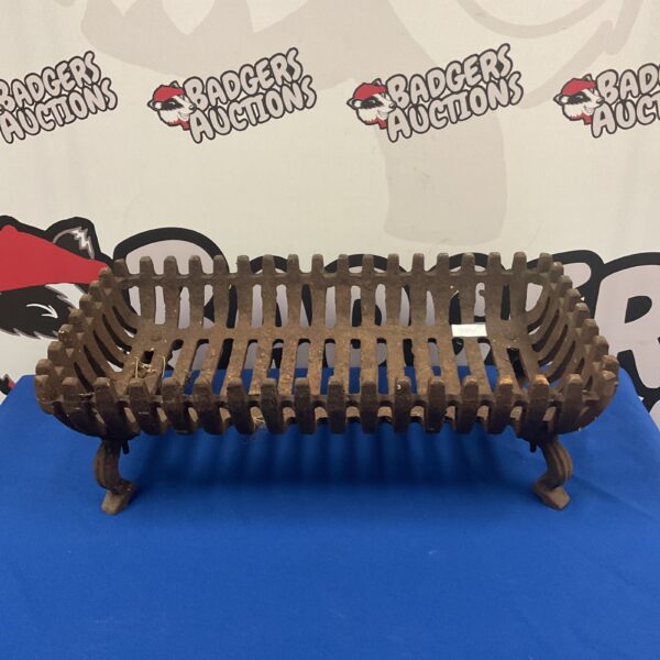 Vintage wrought iron fireplace grate for a classic hearth.