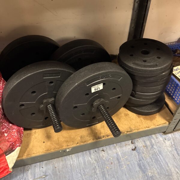 Stack of vinyl dumbbell weights for home fitness.