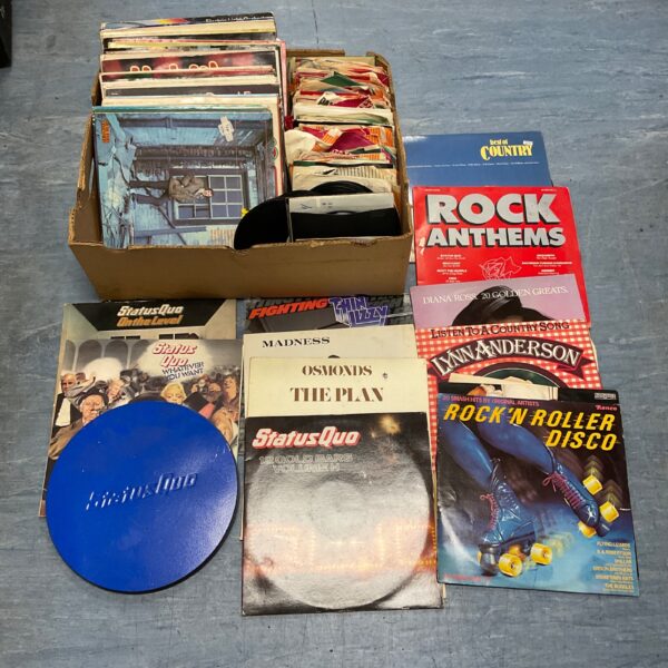 Vintage vinyl record collection featuring Status Quo, Thin Lizzy, and Madness.