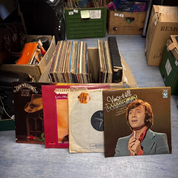 Box of mixed twelve-inch vinyl records for sale.
