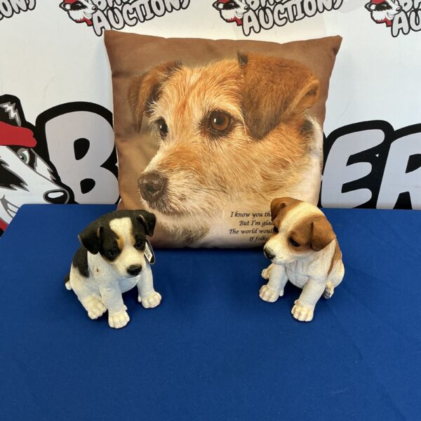 Vivid Arts dog ornaments displayed on a cushion.