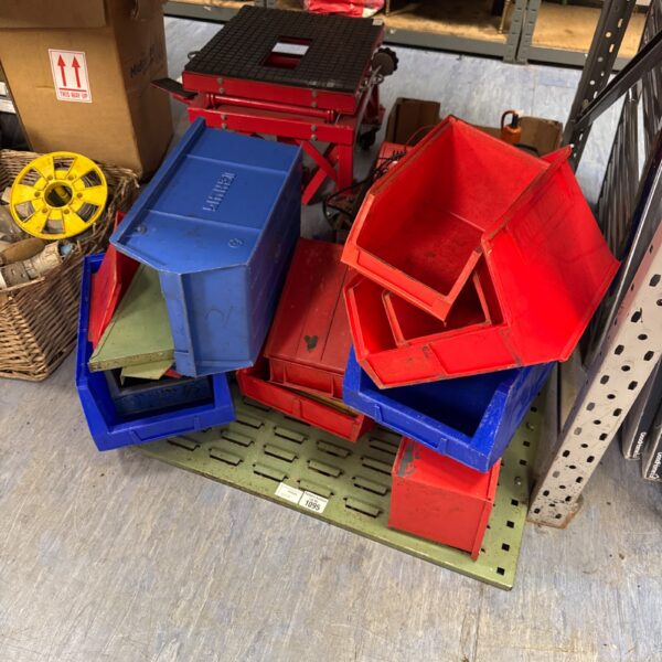 Blue, red, and green plastic trays in a wall mounted organiser.
