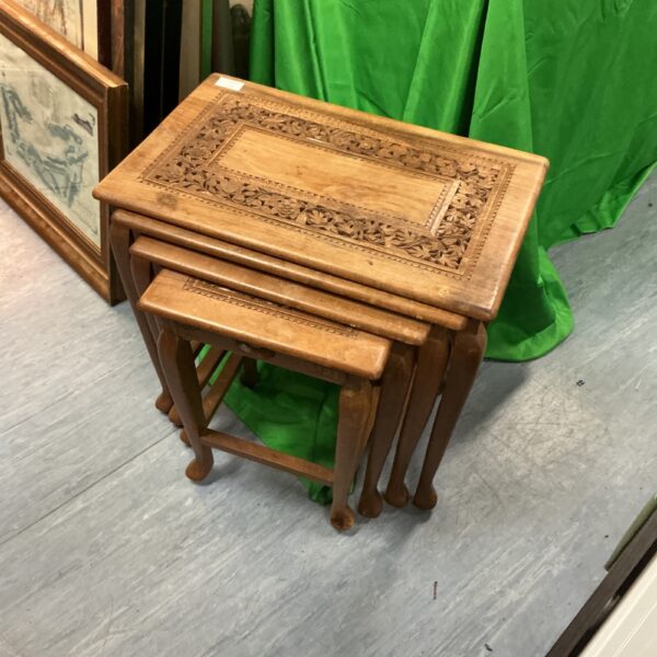 Hand carved walnut nest of tables with intricate detailing.