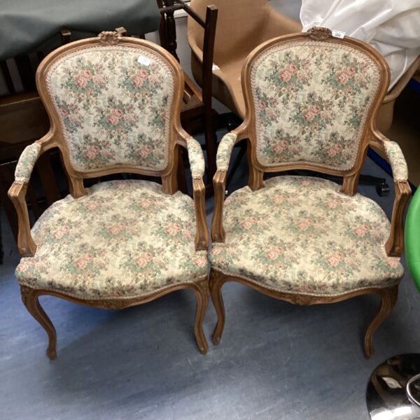 Pair of antique walnut Ricoco armchairs with floral upholstery.