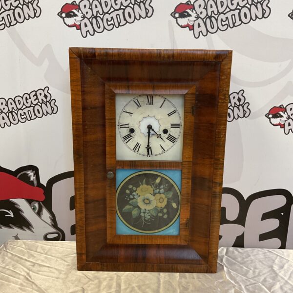 Antique Waterbury Clock Co. wall clock with floral design.