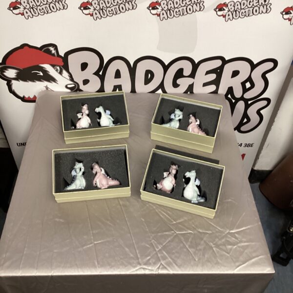 Four boxes of Welina Lover Dragon figurines displayed together.