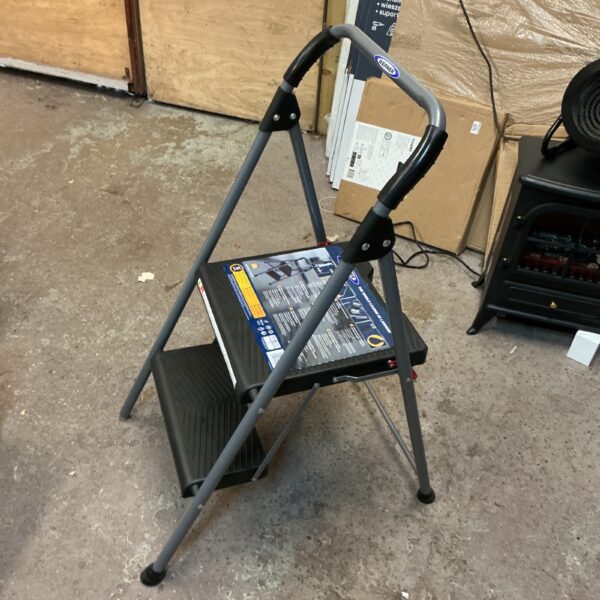 Aluminium Werner step ladder, folded for storage.