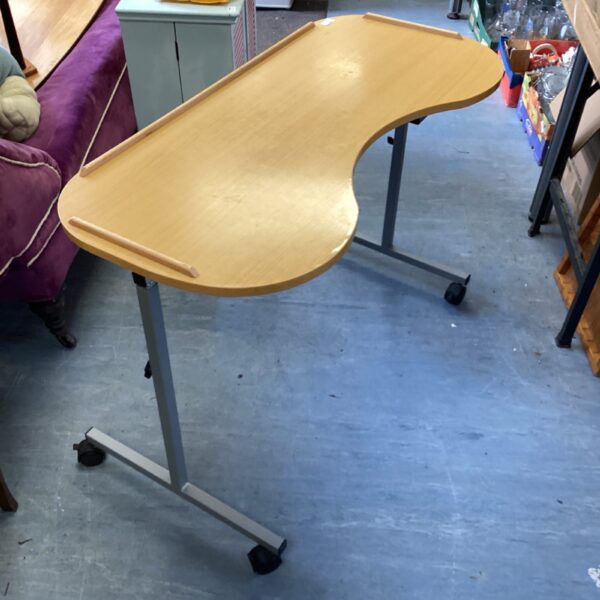 Wheeled height adjustable over chair desk for laptops and study.