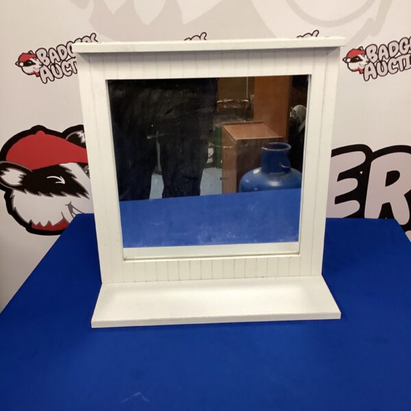 Vintage white dressing table mirror with curved frame.