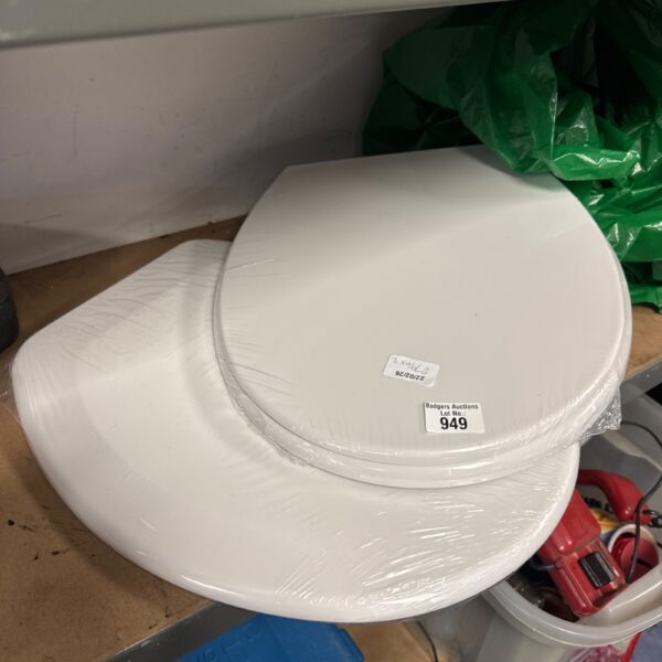 New white toilet seats in original packaging, ready for installation.