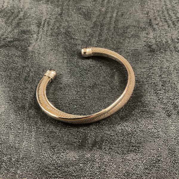 Close-up of a whitemetal mesh twist bracelet.