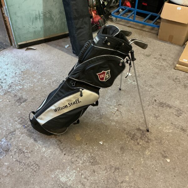 Black and white Wilson Staff stand golf bag on display.