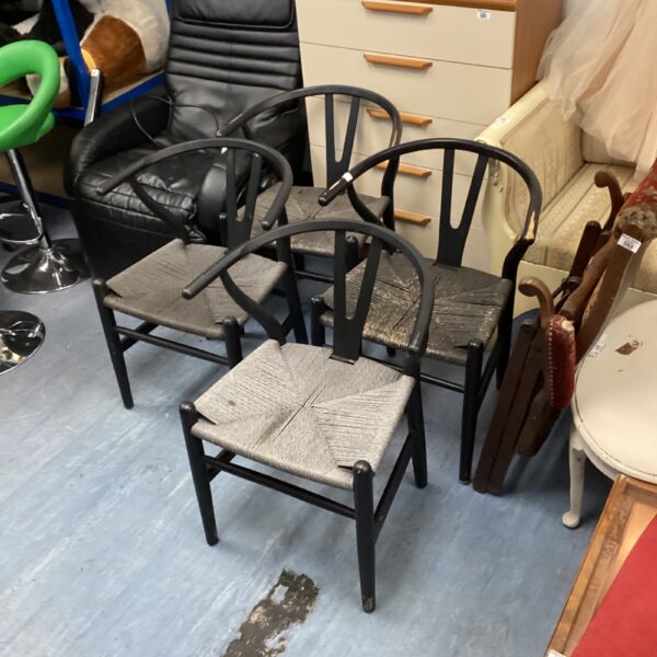 Set of four wishbone dining chairs in beechwood with woven seats.